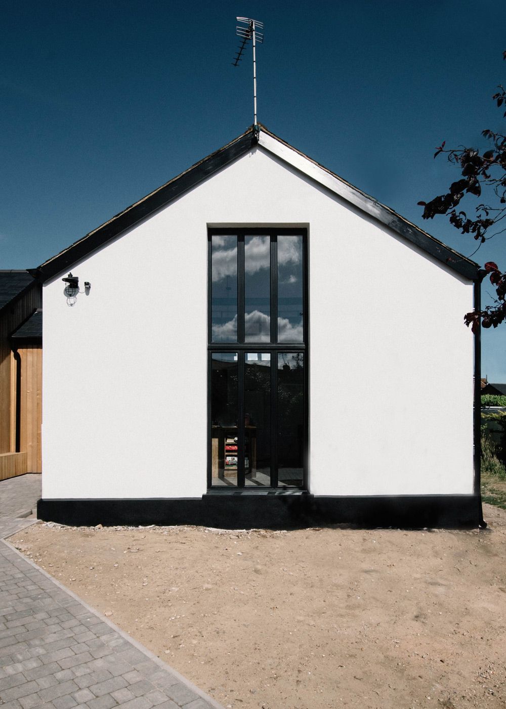 A white house with a black roof and black windows in a Retrofit Consultancy in Battle