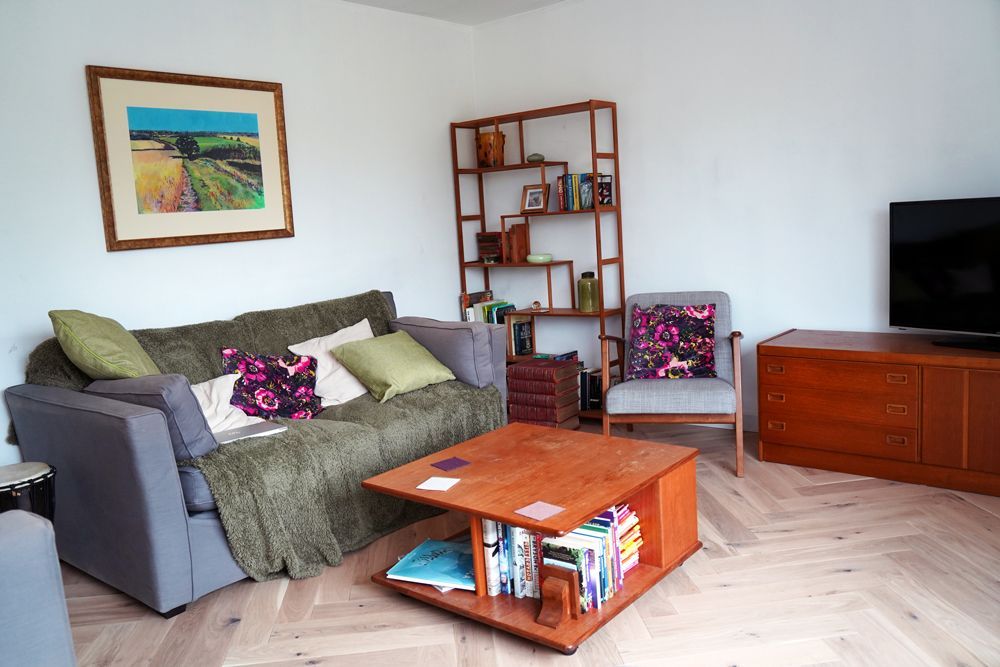 A living room with a couch , chair , coffee table and television  in a Passivhaus New Builds in East Sussex