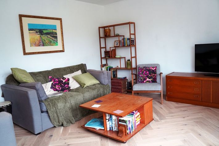 A living room with a couch , chair , coffee table and television in East Sussex