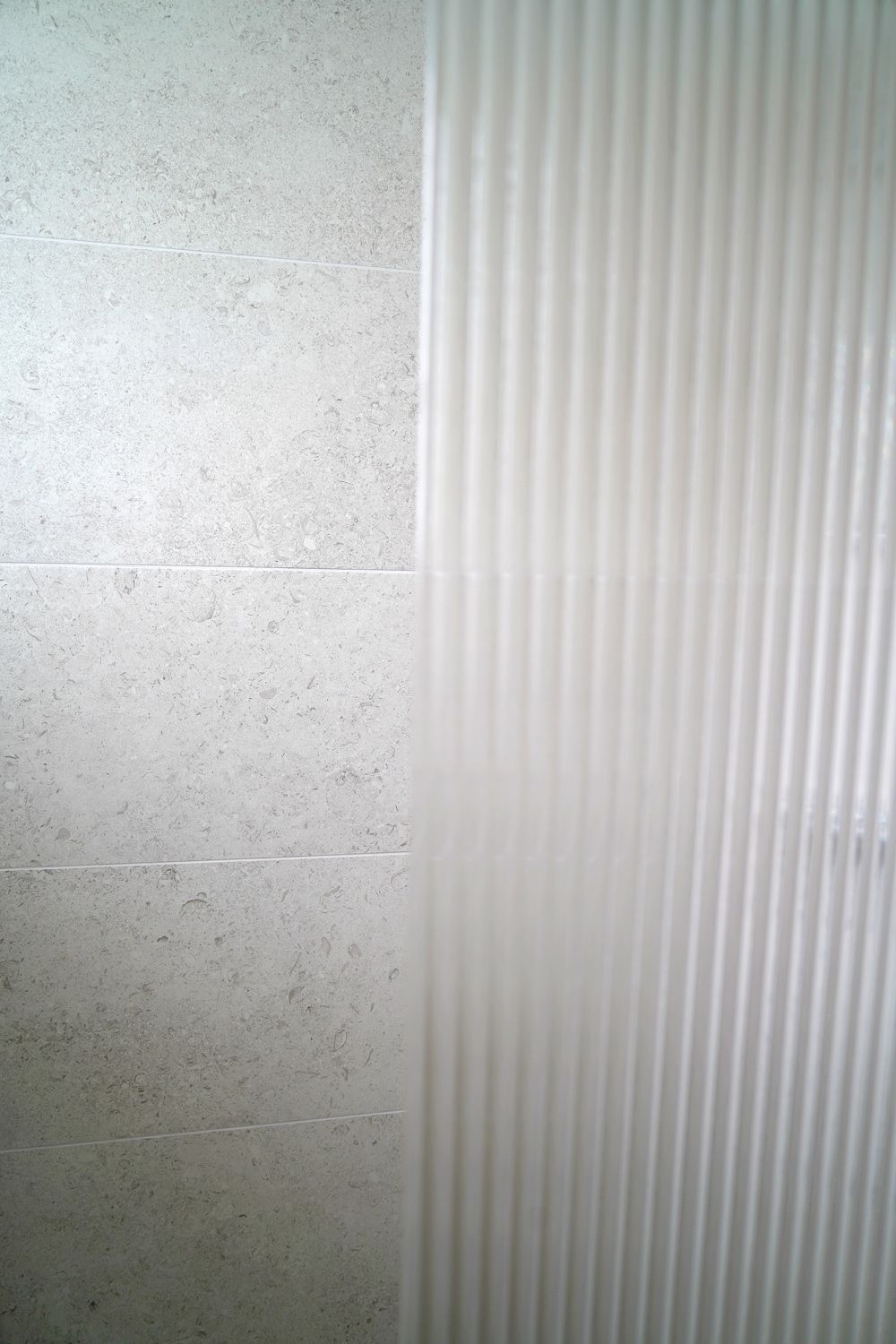 A close up of a shower curtain on a wall  in a Construction Management in East Sussex