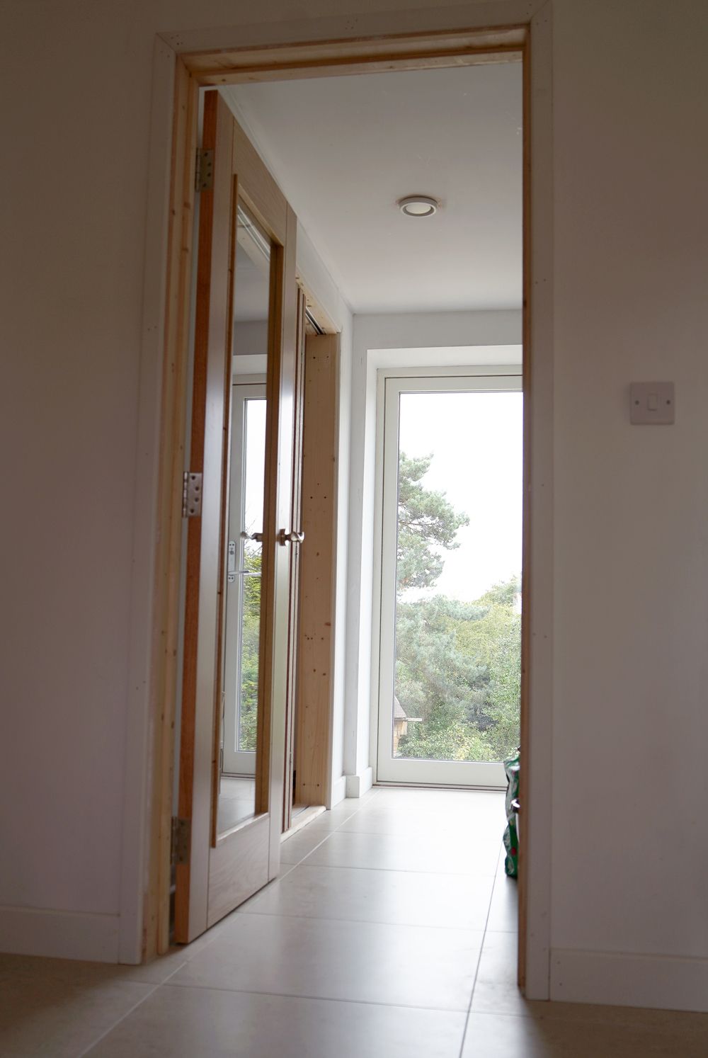 A hallway with a door open and a window  in a Retrofit Consultancy in East Sussex
