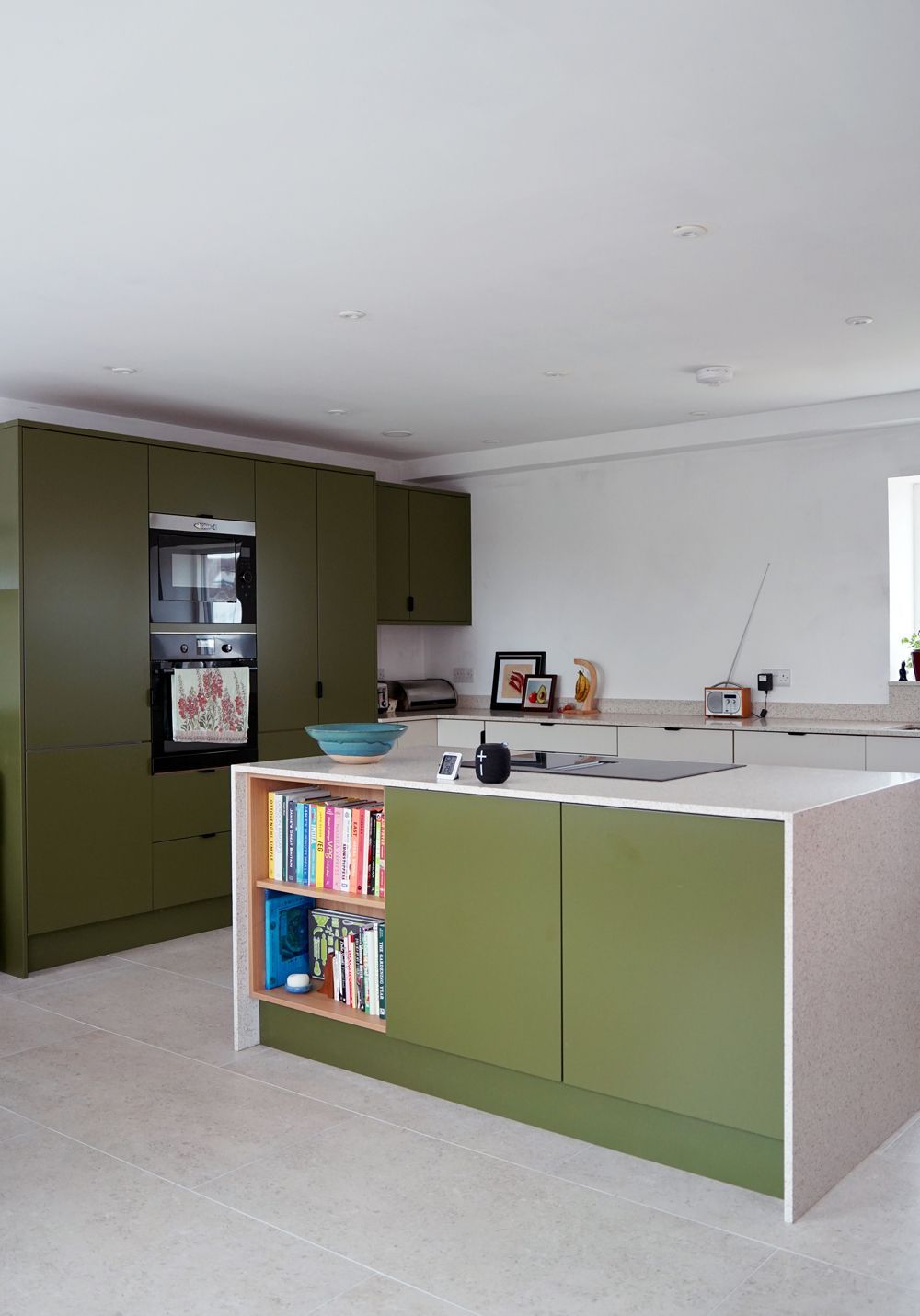 A kitchen with green cabinets and white counter tops  in a Construction Management in East Sussex