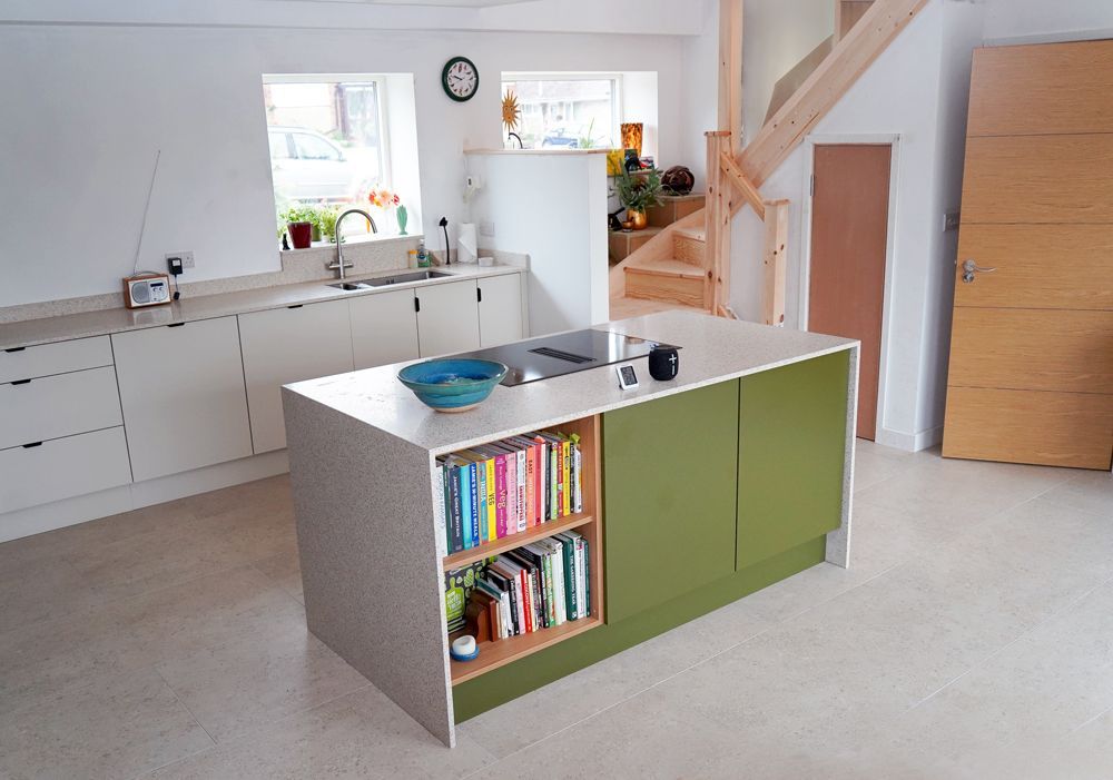 A kitchen with green cabinets and a bookshelf  in a Construction Management in East Sussex