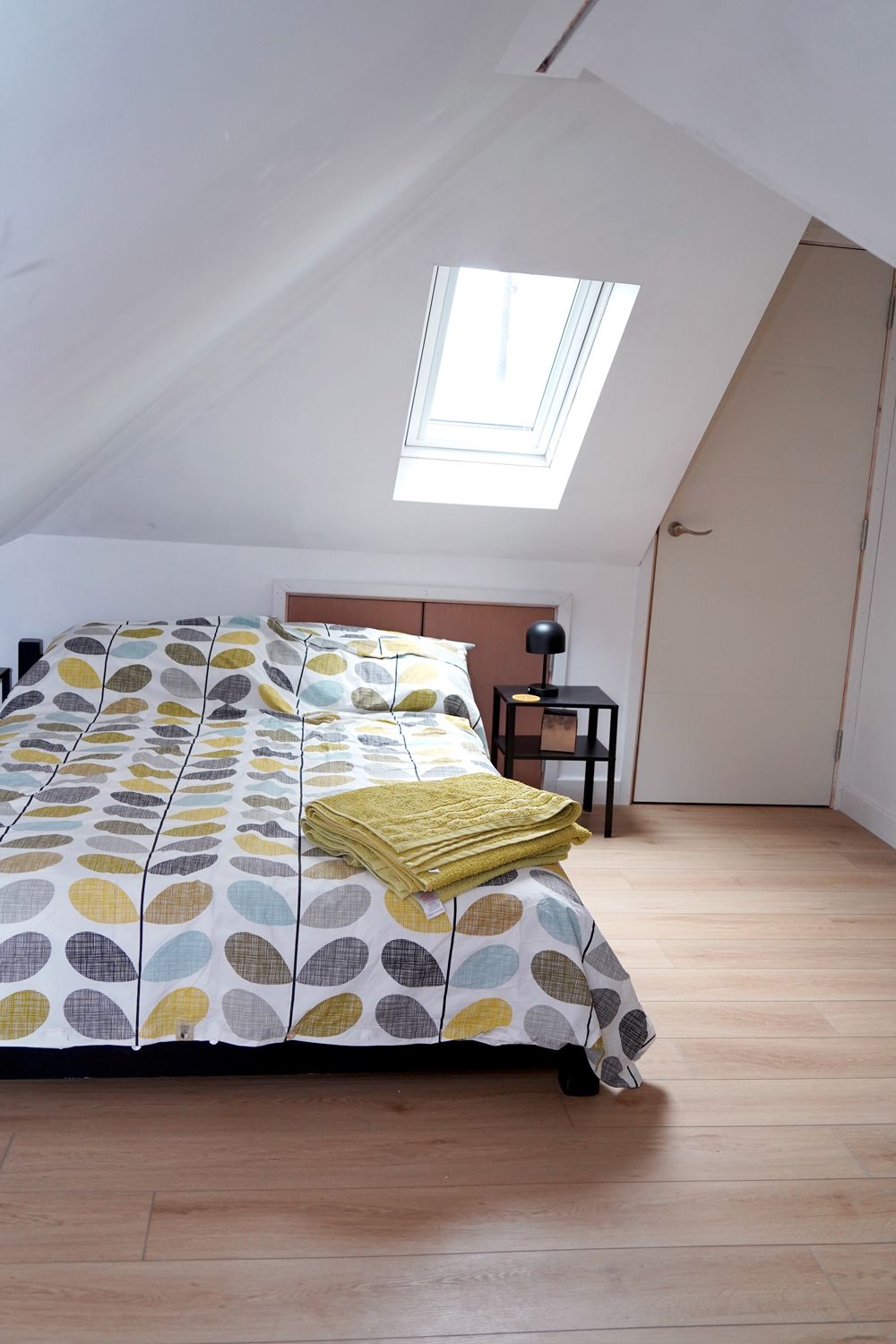 A bedroom with a bed and a skylight in the ceiling  in a Retrofit Consultancy in East Sussex
