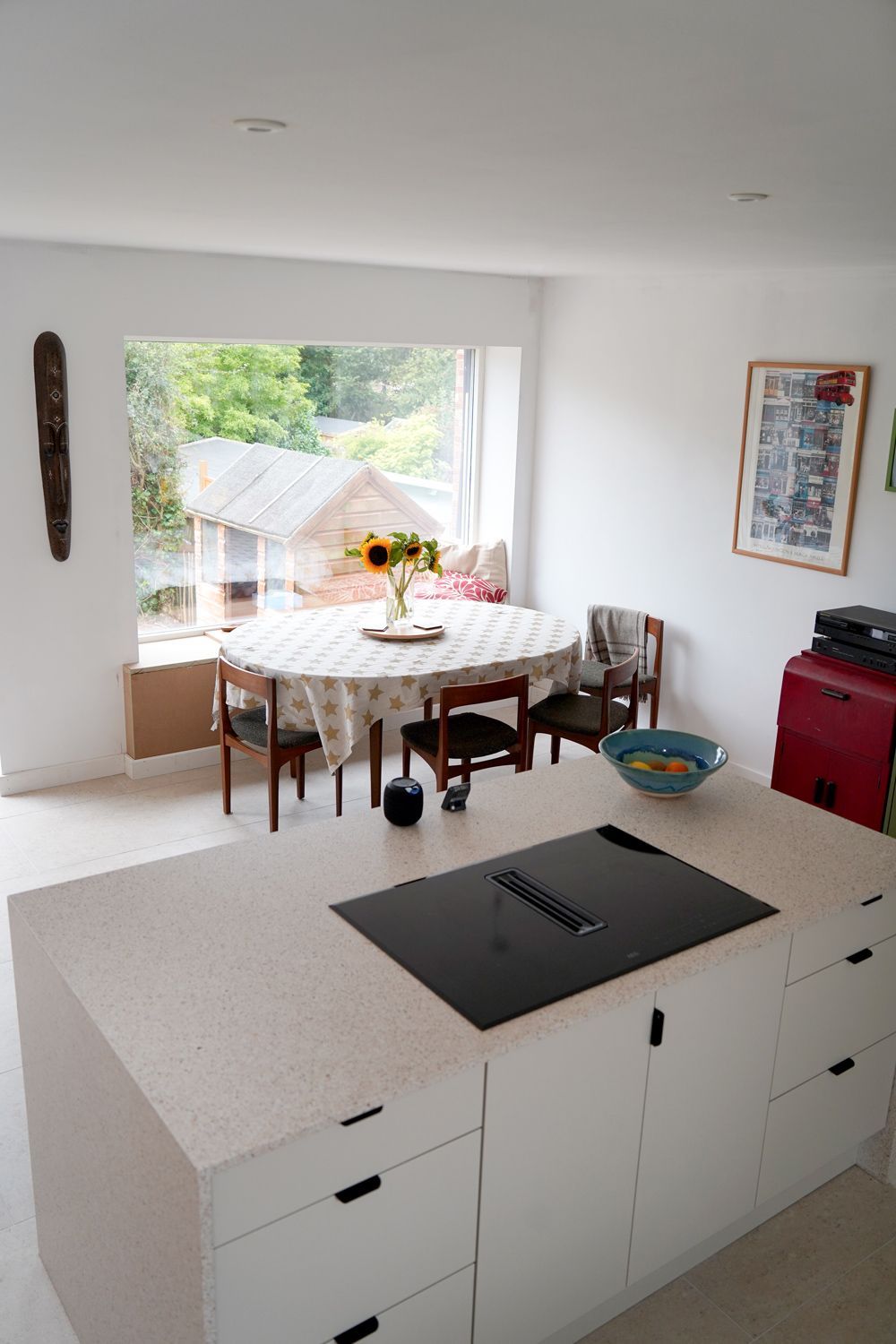 A kitchen with a table and chairs and a stove top oven  in a Large-Scale Retrofitting in East Sussex