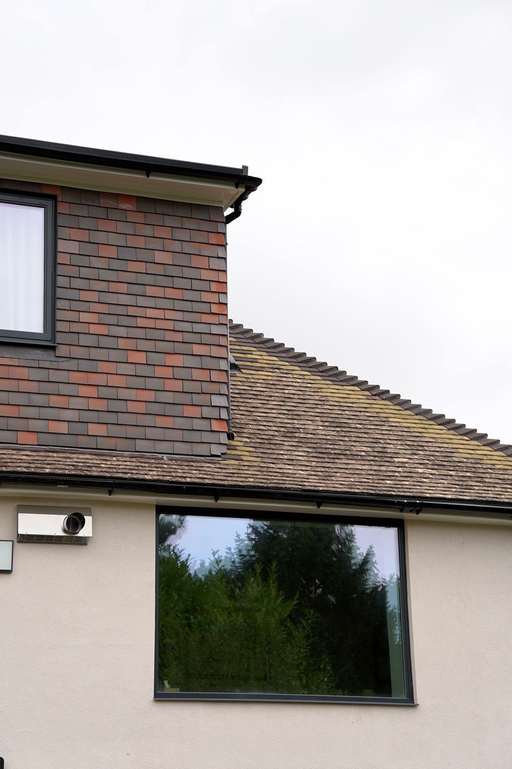 A brick house with a window and a roof  in a Retrofit Consultancy in East Sussex