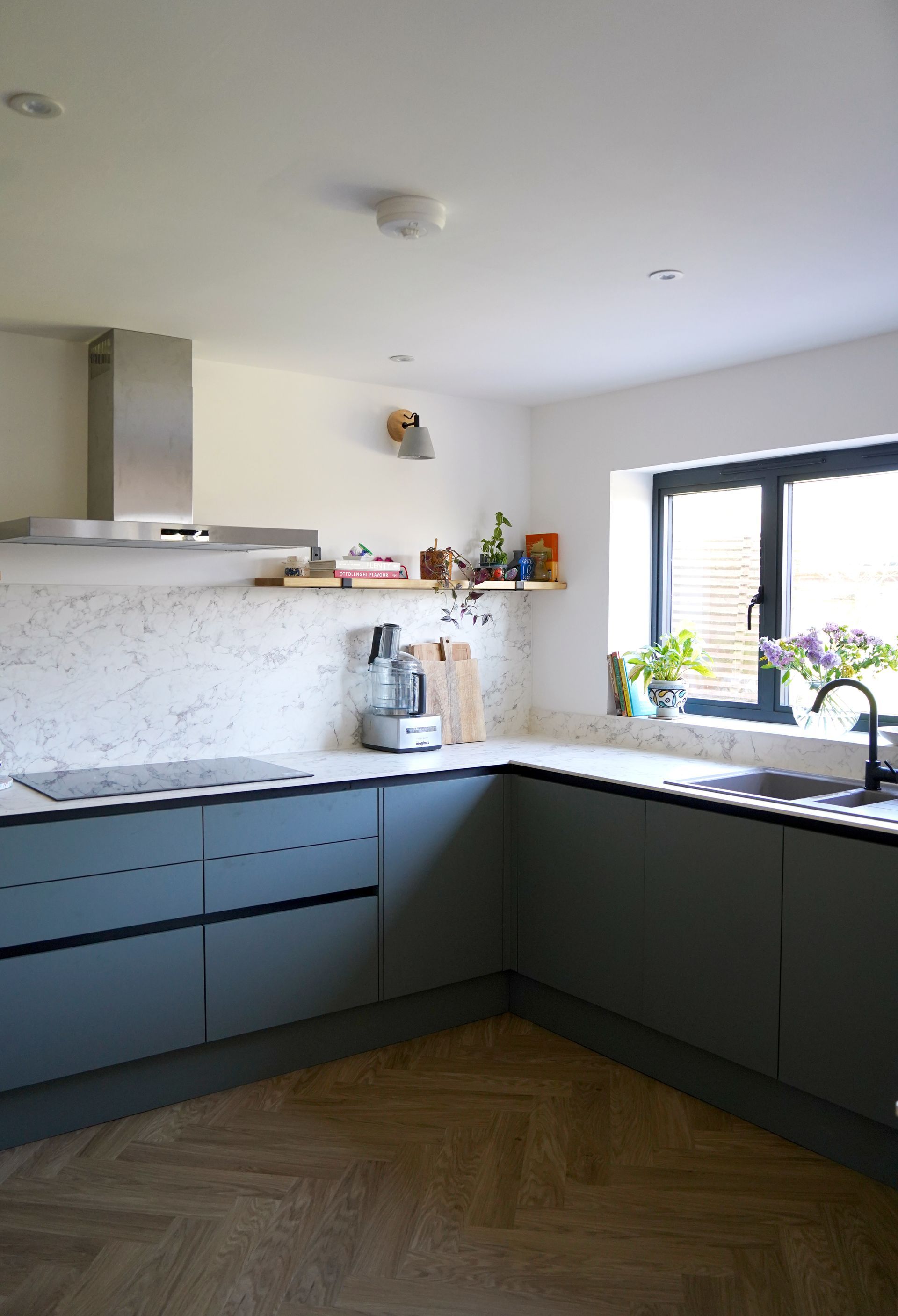 A small wooden building with sliding glass doors in a backyard in a Passivhaus New Builds in Rye