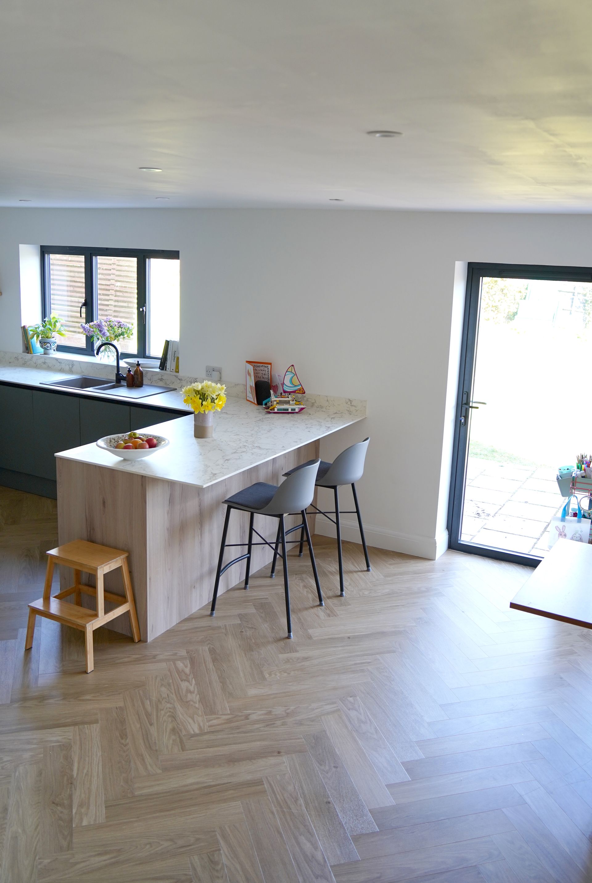 A living room with a couch , chair , coffee table and television in East Sussex