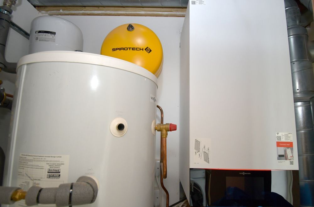 A water heater and a boiler are in a room  in a Retrofit Consultancy in East Sussex