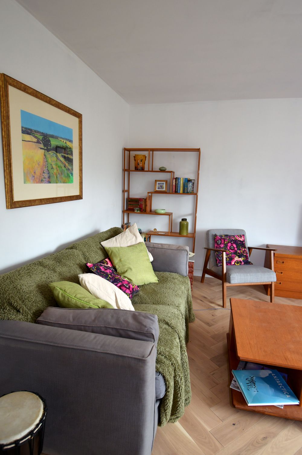 A living room with a green couch and a drum  in a Large-Scale Retrofitting in East Sussex