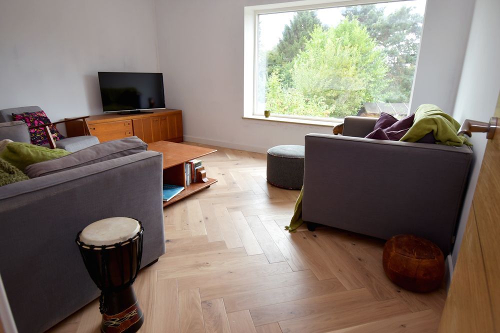 A living room filled with furniture and a television  in a Large-Scale Retrofitting in East Sussex