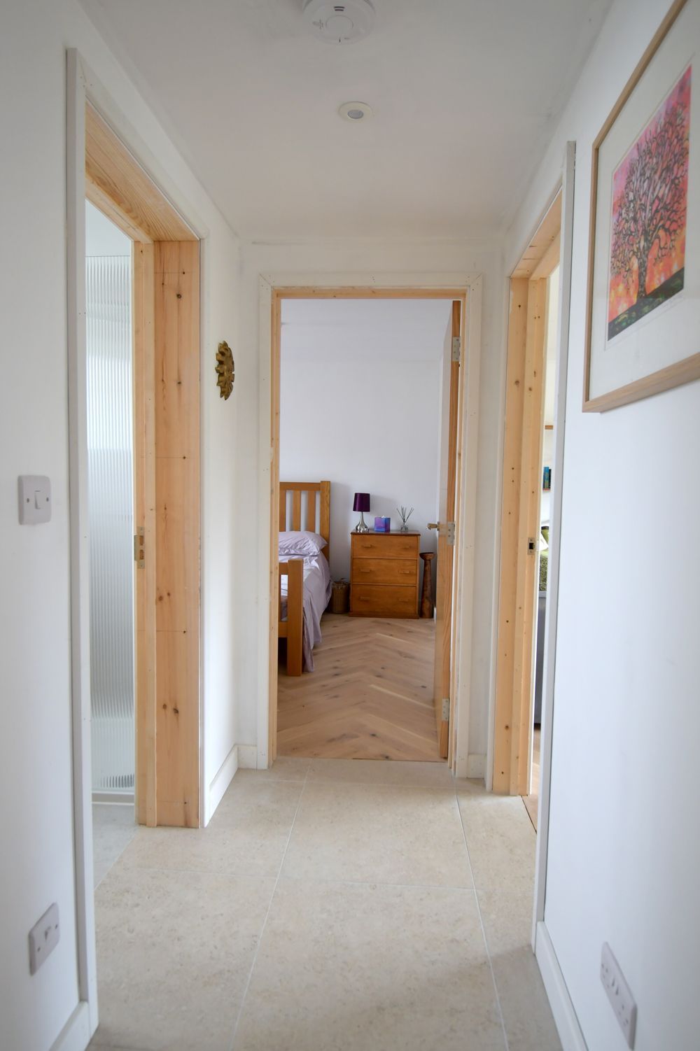 A hallway leading to a bedroom with a picture on the wall  in a Construction Management in East Sussex