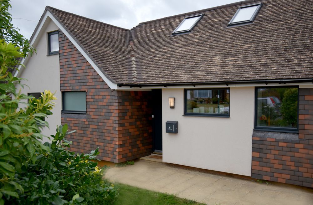 A house with a brick facade and a roof with two skylights  in a Retrofit Consultancy in East Sussex