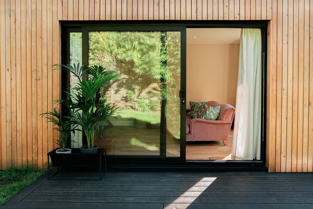 There is a sliding glass door leading to a living room in a Construction Management in Tenterden