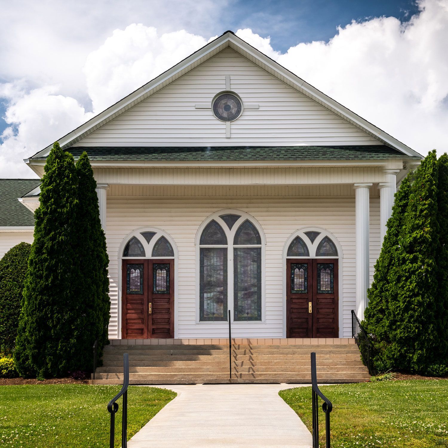 A white church with a walkway leading to it