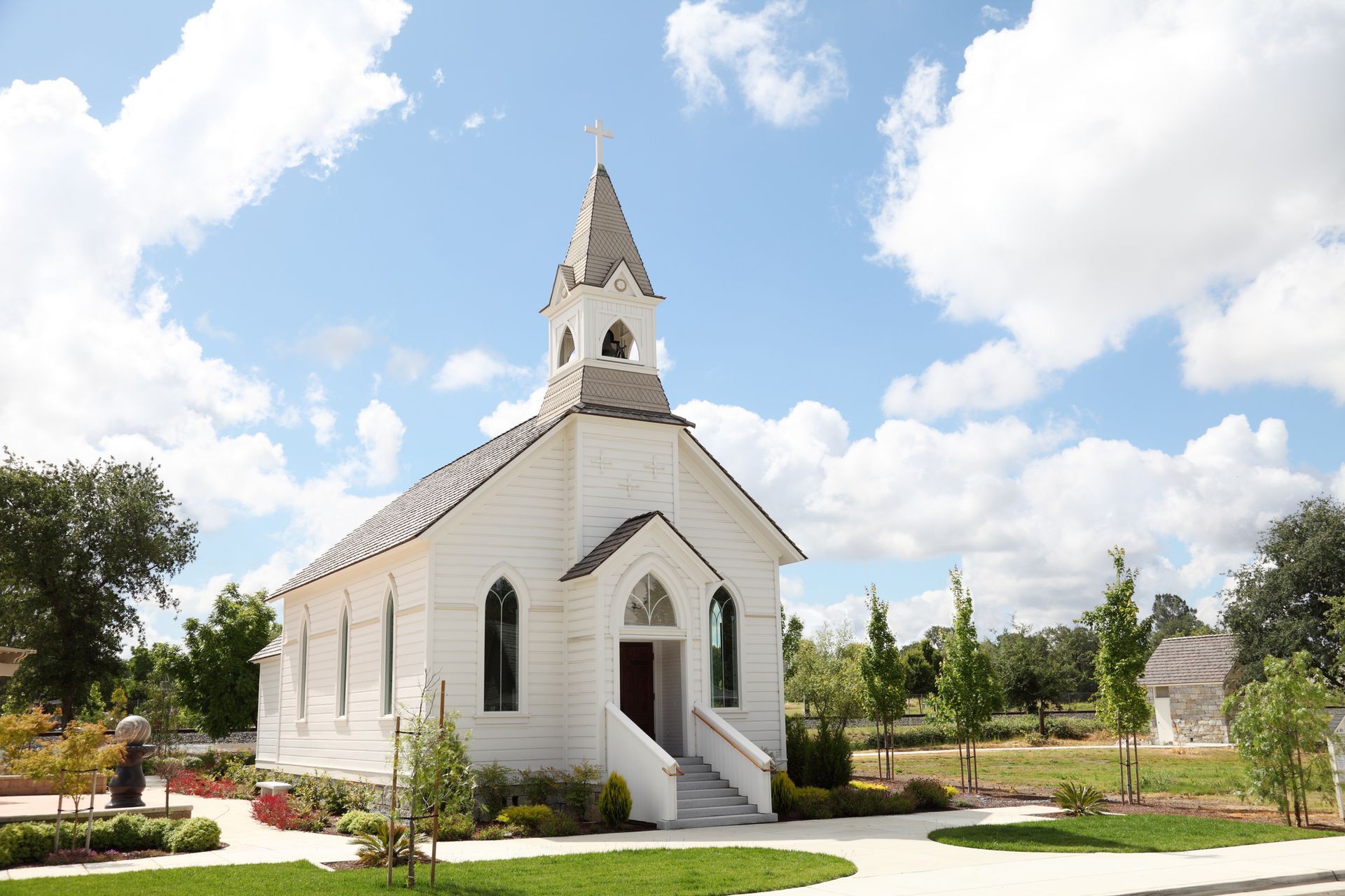 A small white church with a steeple on top of it