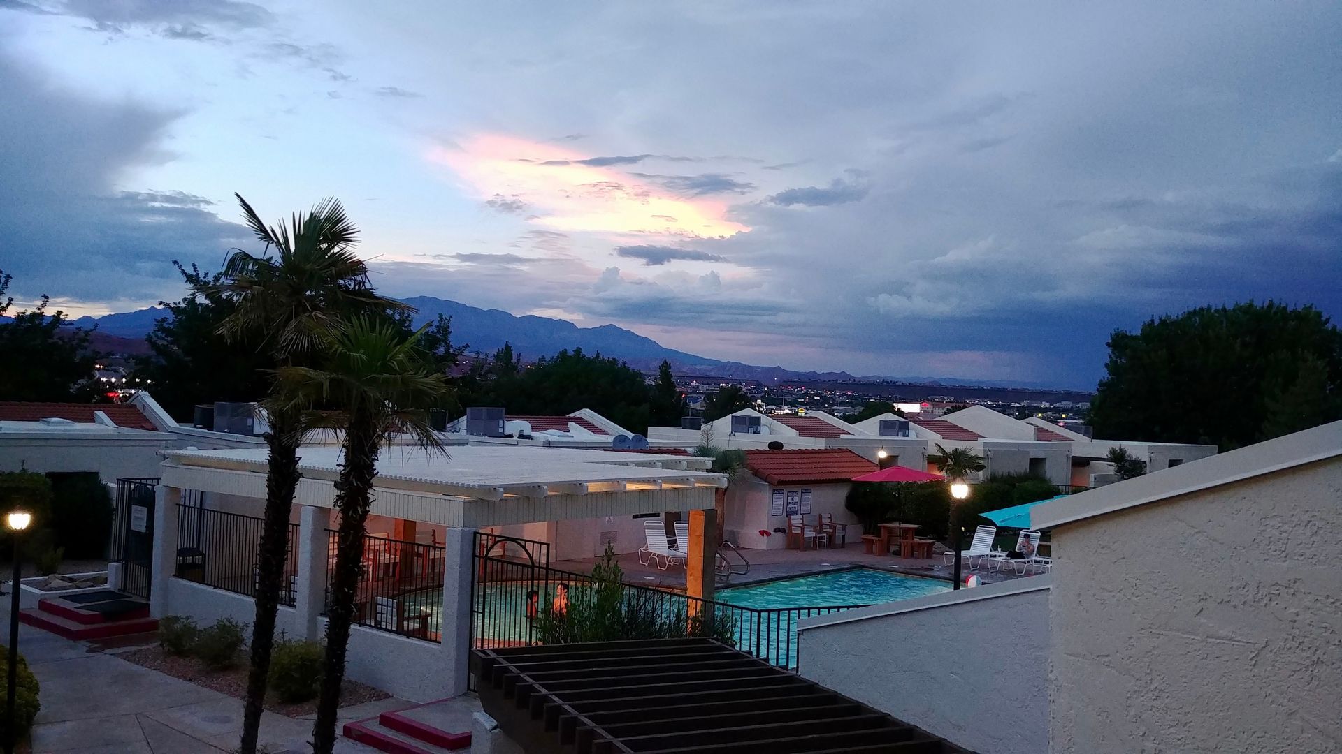 A view of a swimming pool with mountains in the background