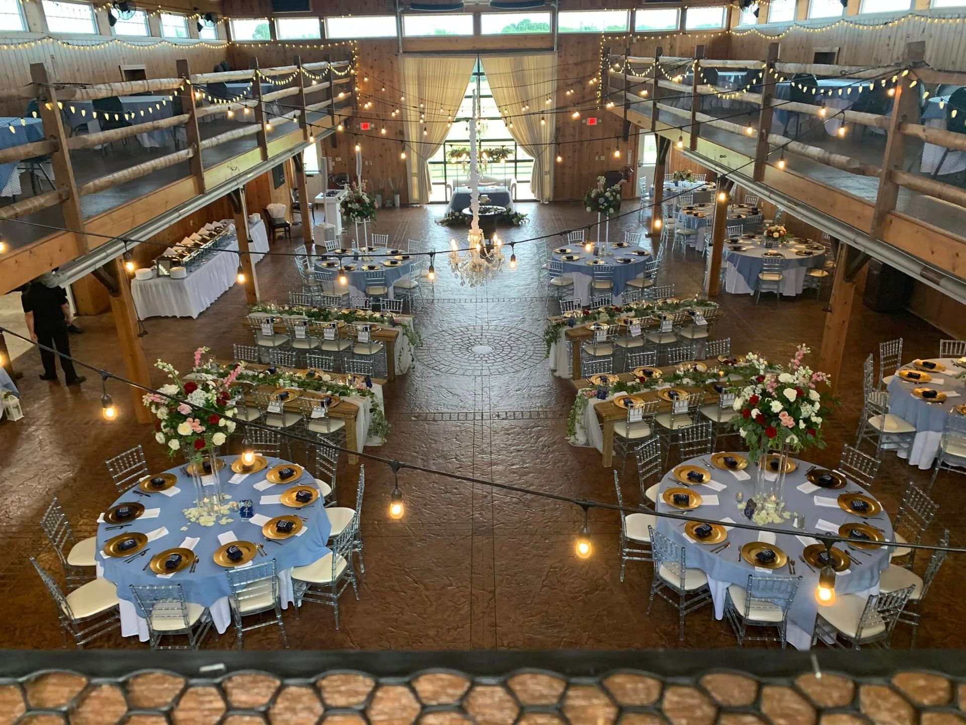 A large room with tables and chairs set up for a wedding reception.