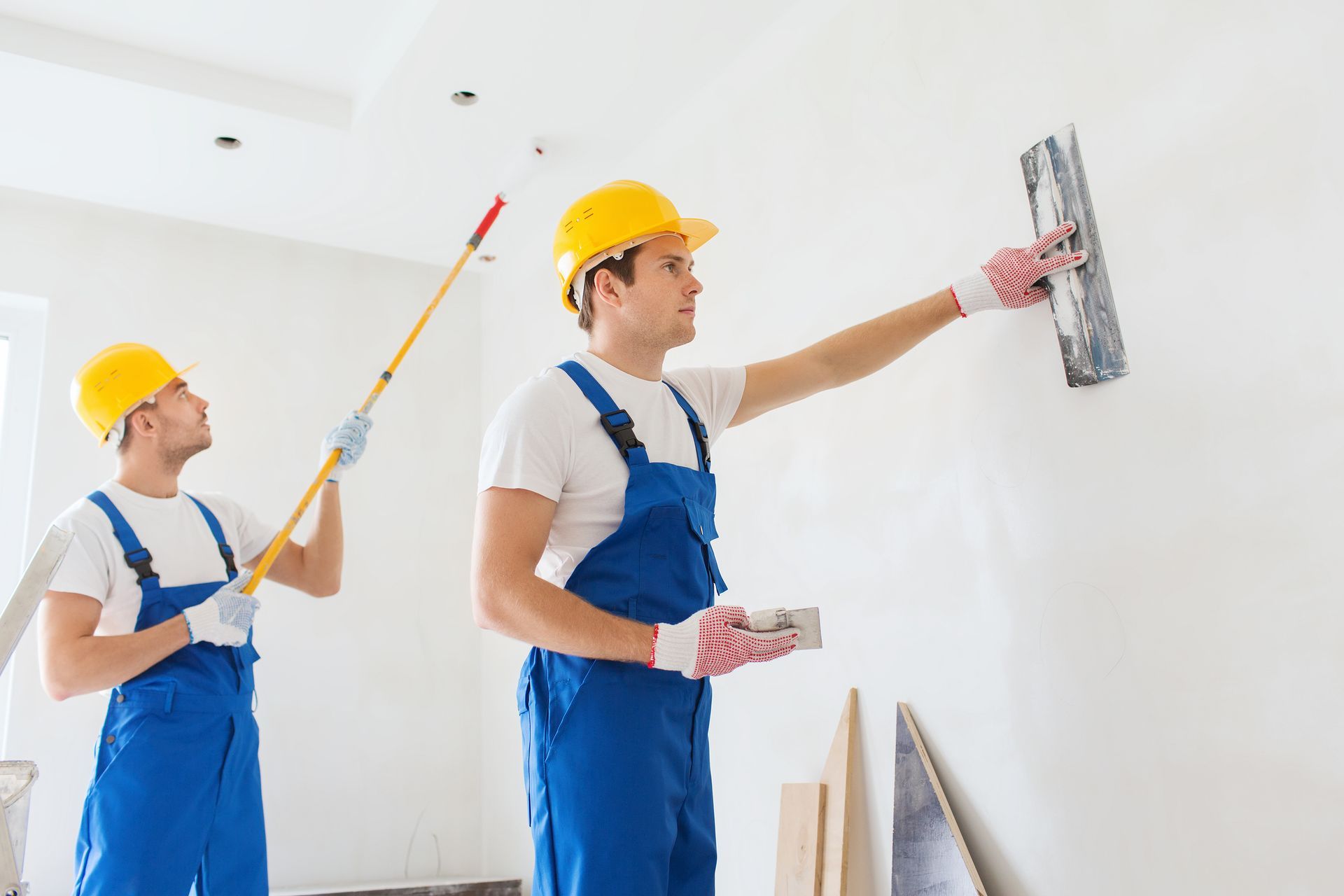 Painting contractors painting a wall with a roller in Pittsburgh, PA. Service provided by Multicolor