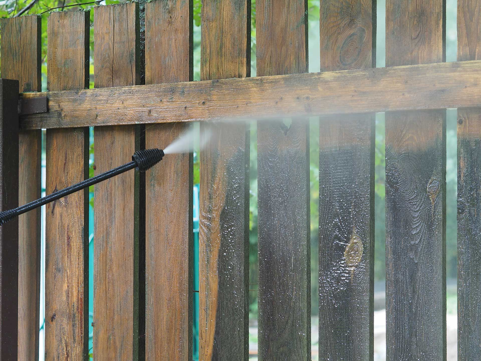  wooden fence with equipment pressure washer