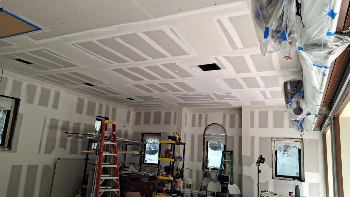 a kitchen under construction with a large island in the middle of the room .