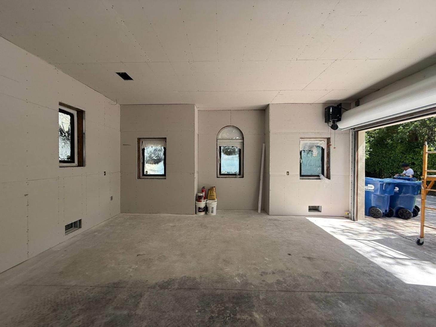 a man is laying tiles on the floor with a trowel .