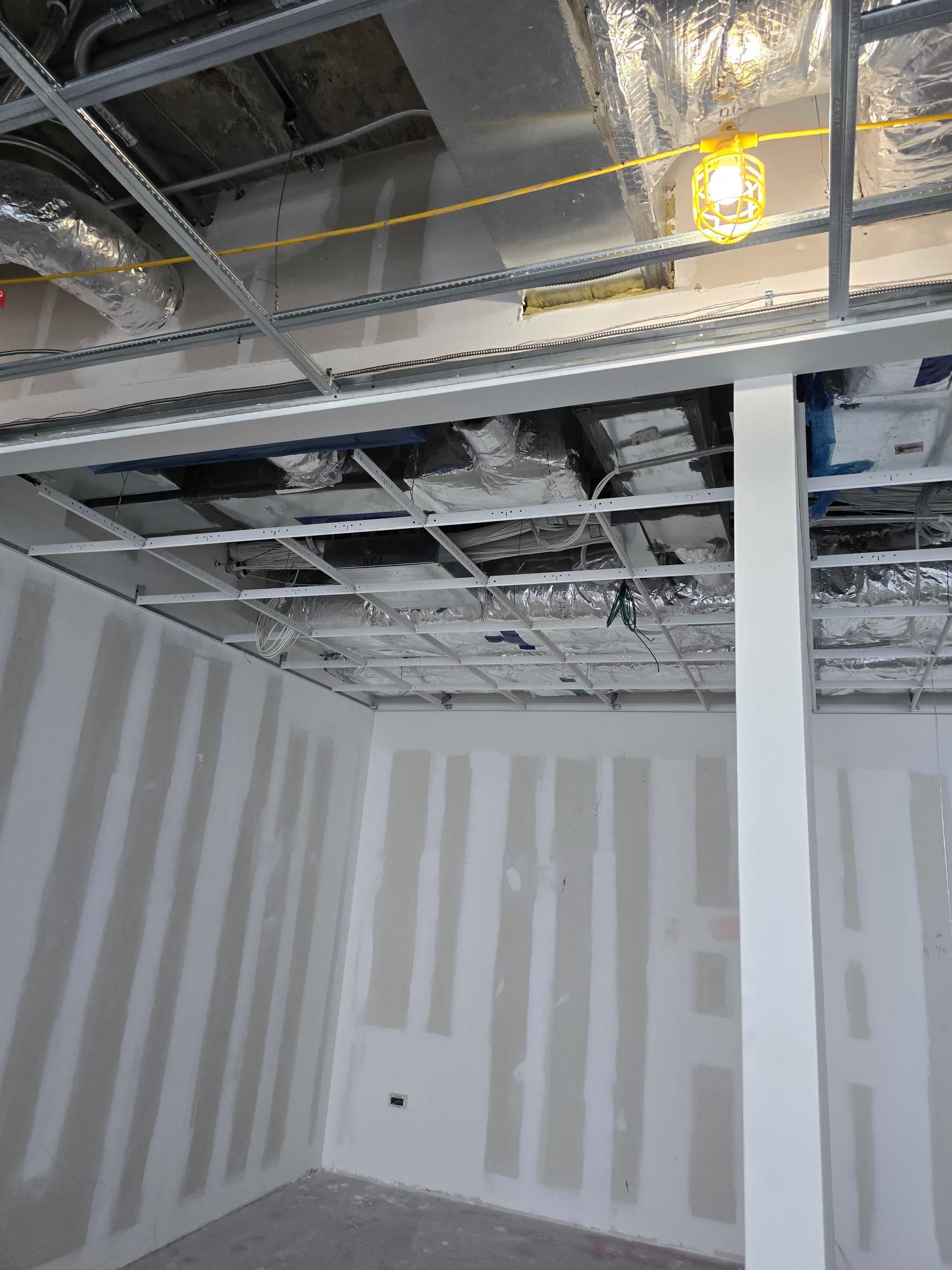 an empty room with a wooden floor and a ladder .