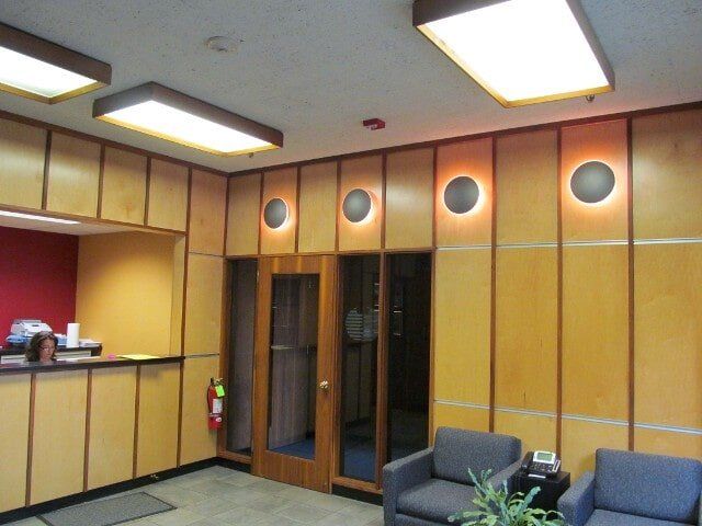 A waiting room with chairs and a fire extinguisher