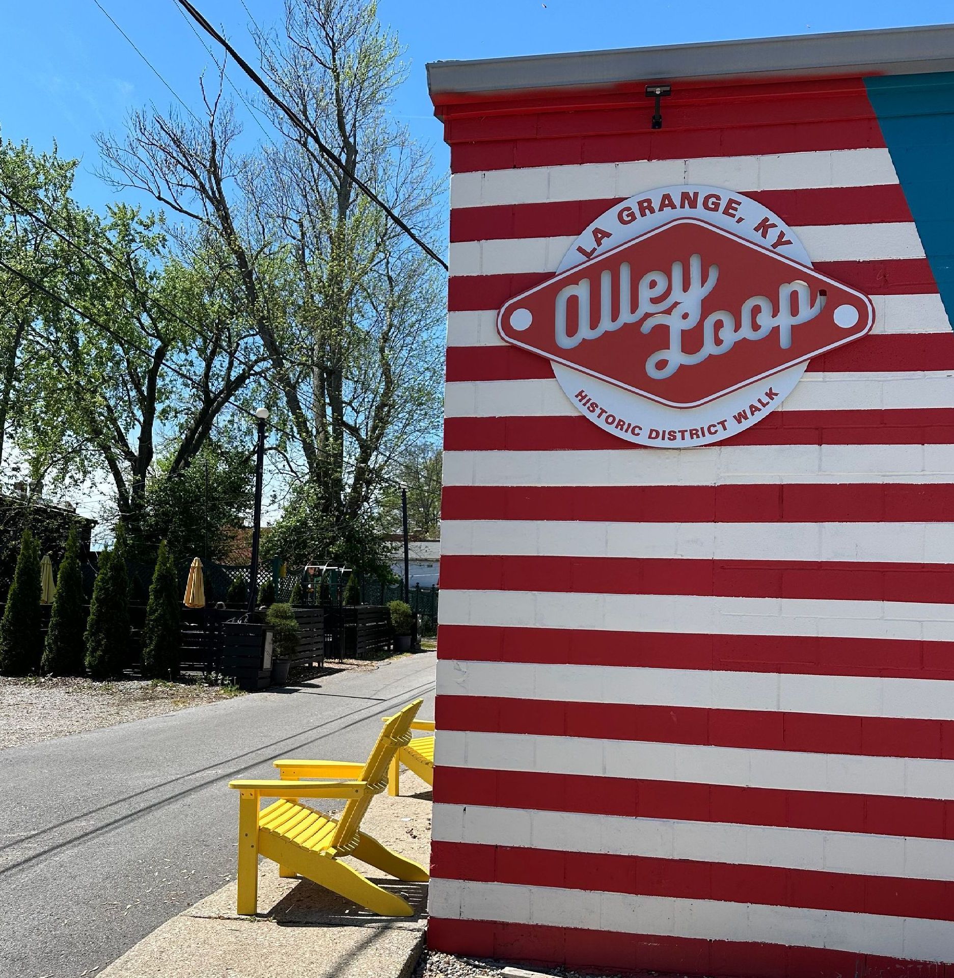 A red and white striped building with a sign that says alley loop
