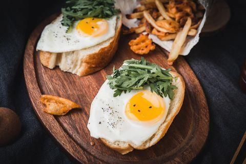 Eggs and toast on wood tray