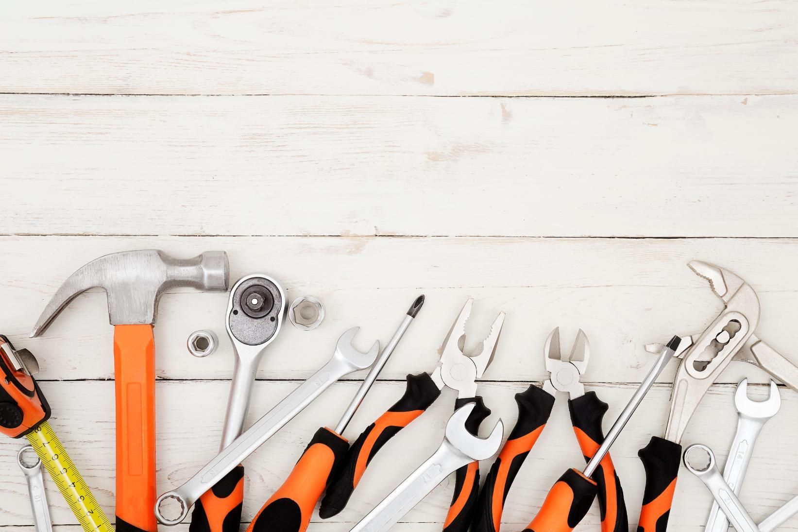 A Bunch Of Tools Are Sitting On A White Wooden Table — Tall Orders Port Macquarie In Port Macquarie, NSW
