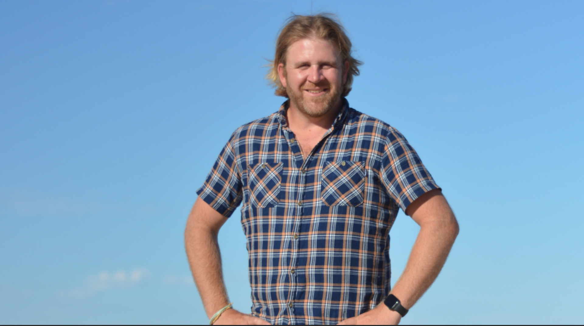 A Group Of Men Are Standing Next To A Golf Cart On A Golf Course — Tall Orders Port Macquarie In Port Macquarie, NSW 