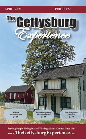 A white house with a red barn on the cover of The Gettysburg Experience April 20024 edition.