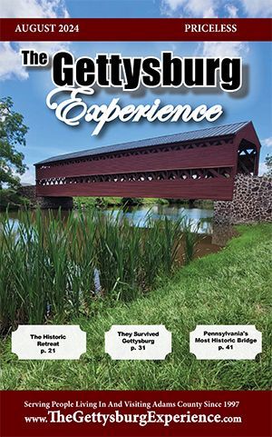 A covered bridge is on the cover of the Gettysburg Experience Magazine. August 2024