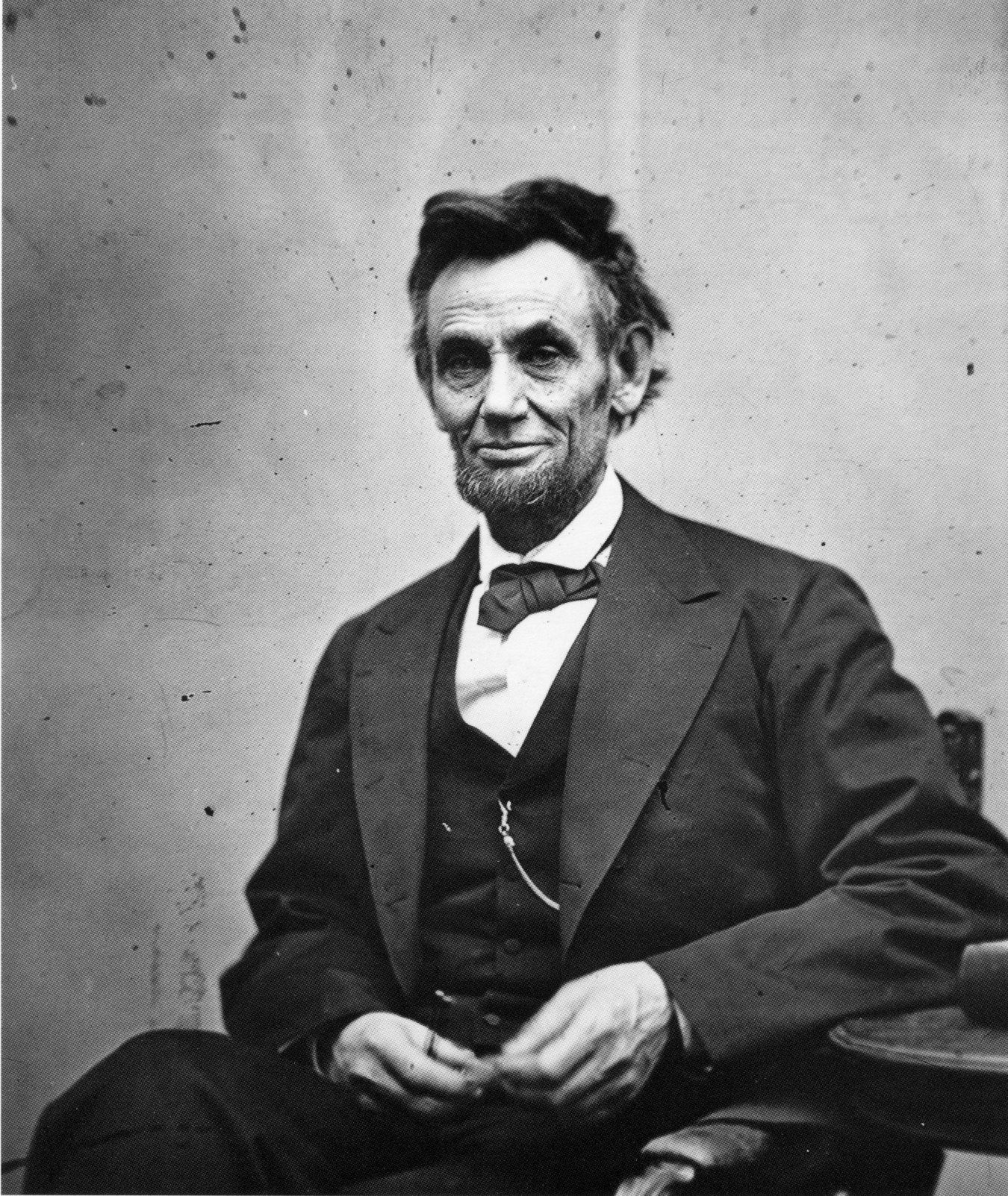 A black and white photo of abraham lincoln sitting in a chair