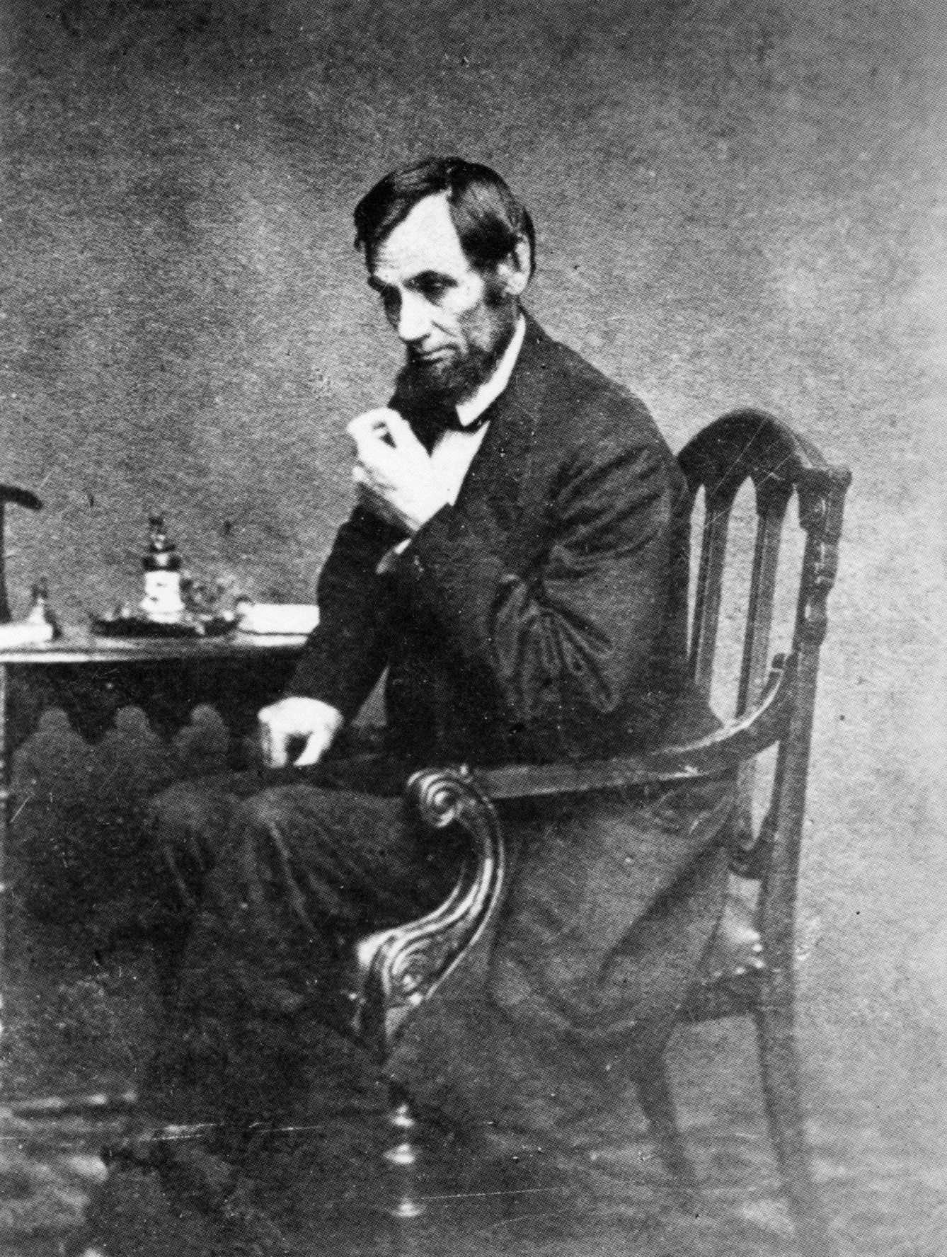 Abraham Lincoln sitting Caption: (Library of Congress)