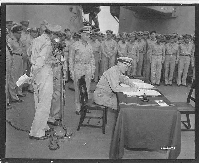 FADM Nimitz signs the Allied copy of the Instrument of Surrender  with the Woo (Victory) Pen, September 2, 1945 (National Archives photo # 111-SC-210630)