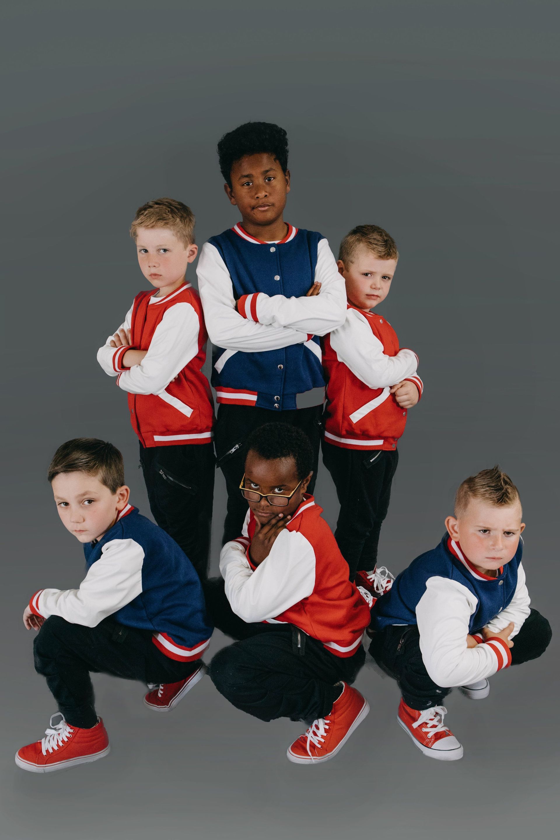 A group of young boys are posing for a picture.