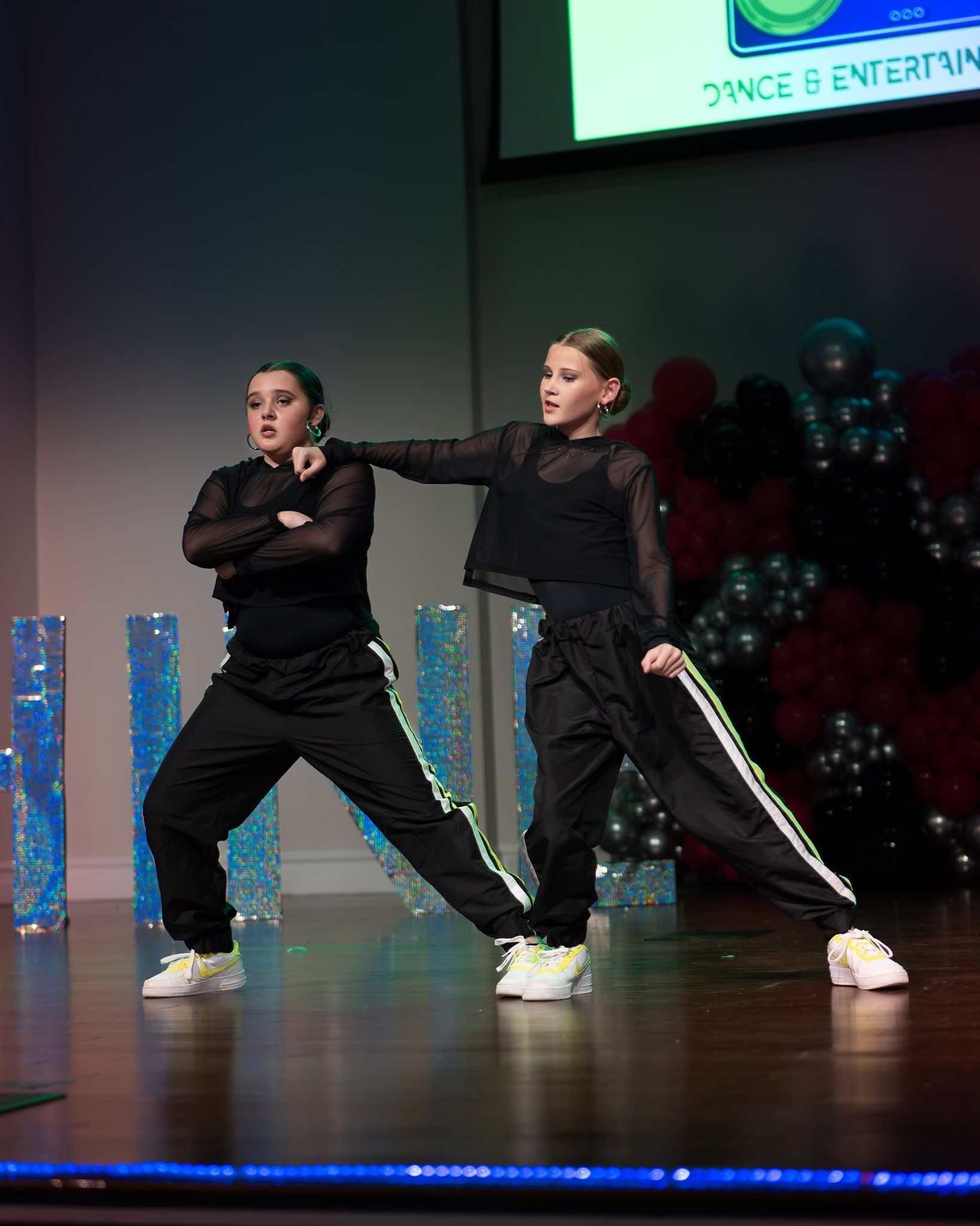A little girl is wearing a blue leotard and a blue tutu.