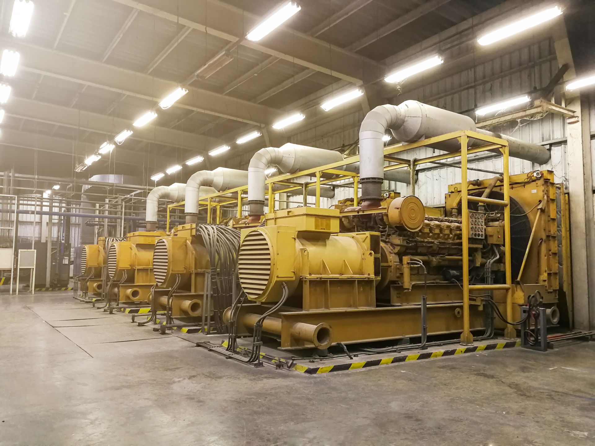 Industrial generators with exhaust systems operating inside a facility during emissions testing.] 
