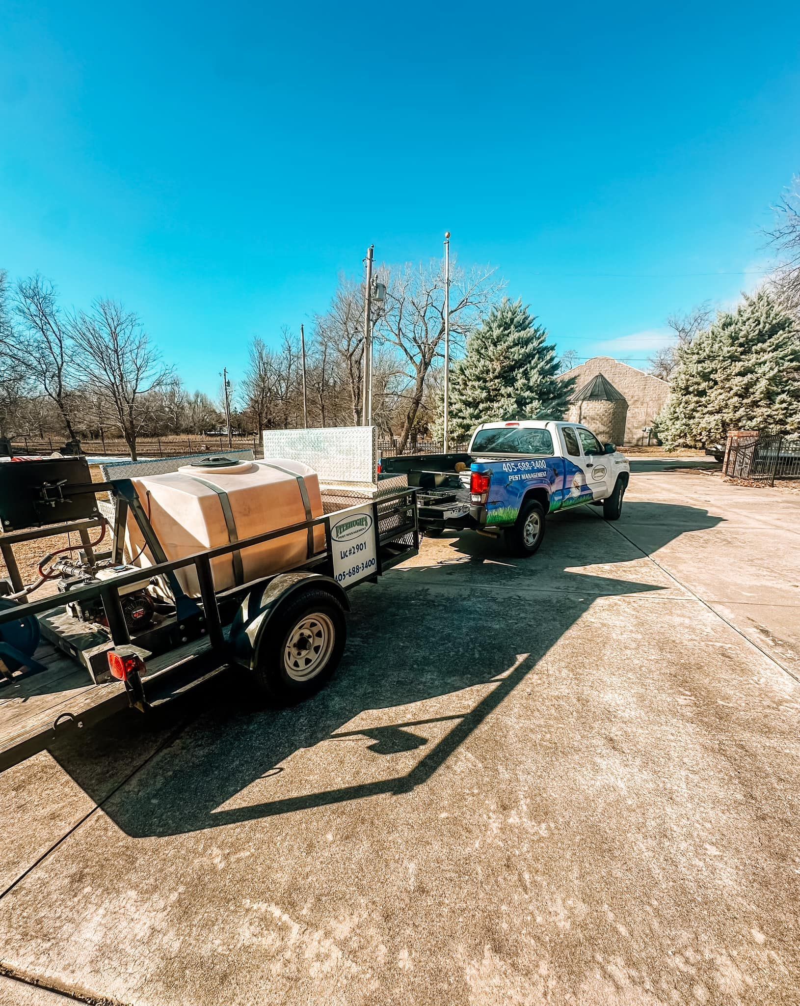 A truck is pulling a trailer with boxes on it.