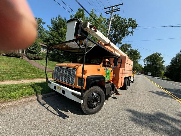 A large orange truck is parked on the side of the road.