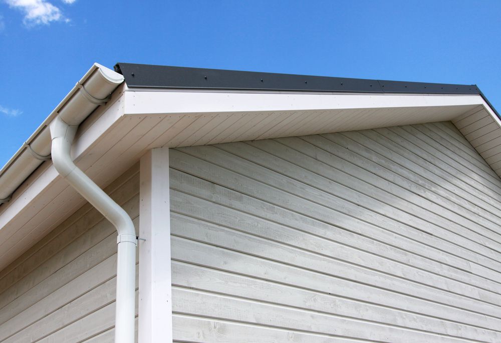 Corner of a House With White Siding and Trim, Black Roof, and White Gutter — Your Craftsmen in Wangi Wangi, NSW