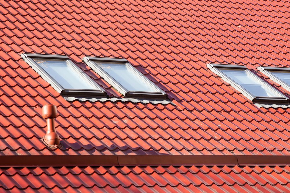 Red Tiled Roof With Three Skylights — Your Craftsmen in Eleebana, NSW