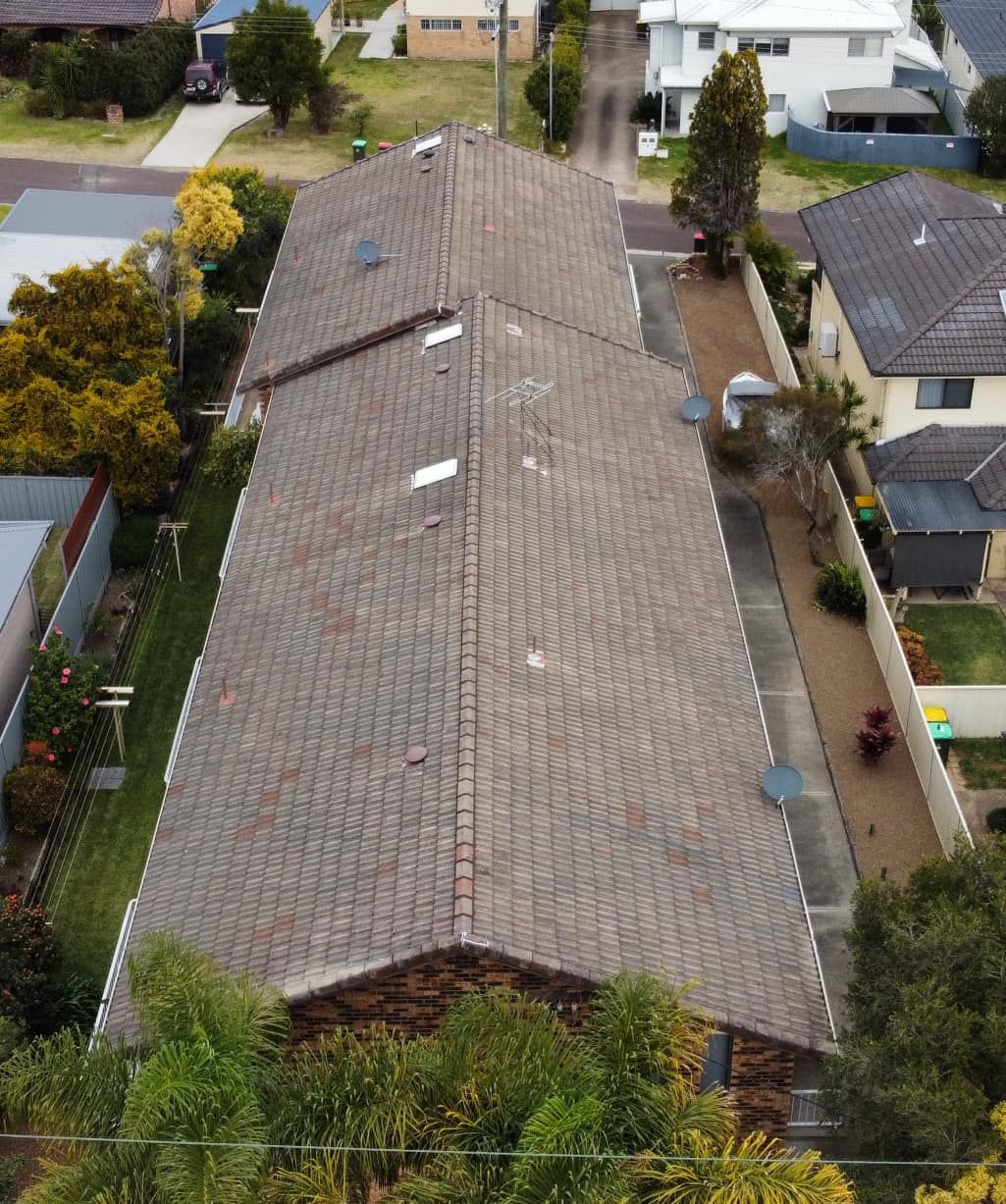 Aerial View of a Long, Dark-tiled Roof on a Residential Building — Your Craftsmen in Eleebana, NSW