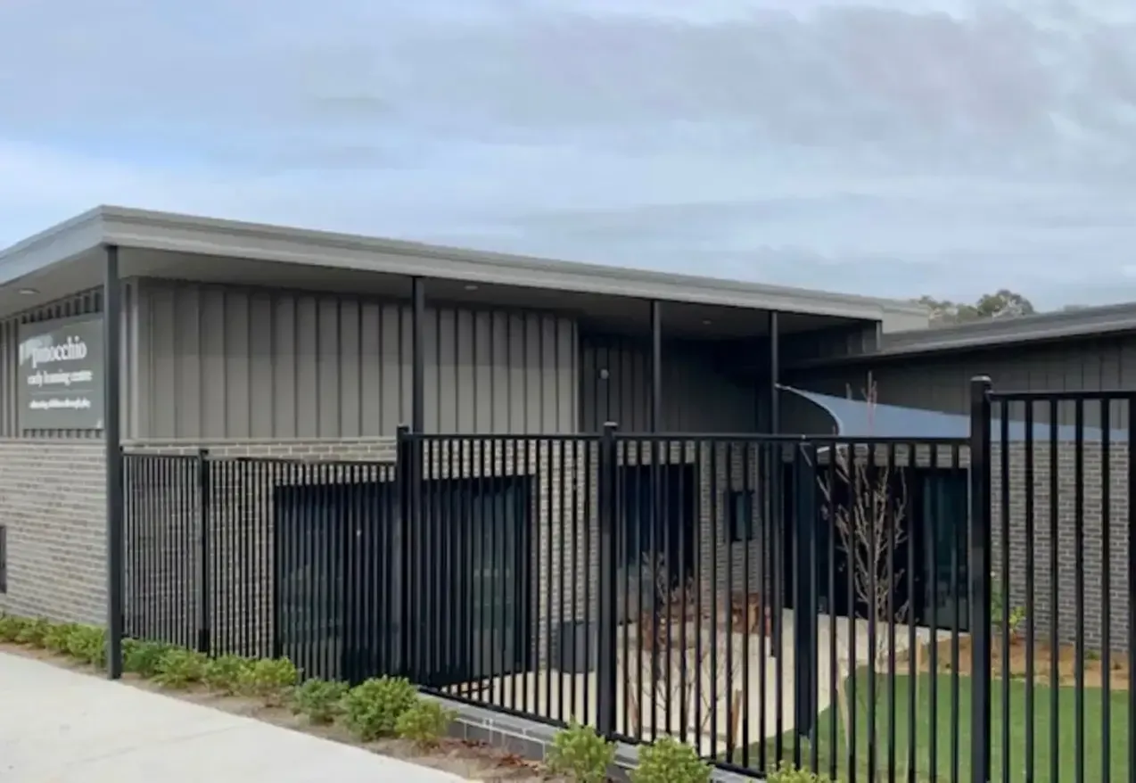 Exterior of a Modern Building With a Metal Fence and Landscaping — Your Craftsmen in Eleebana, NSW