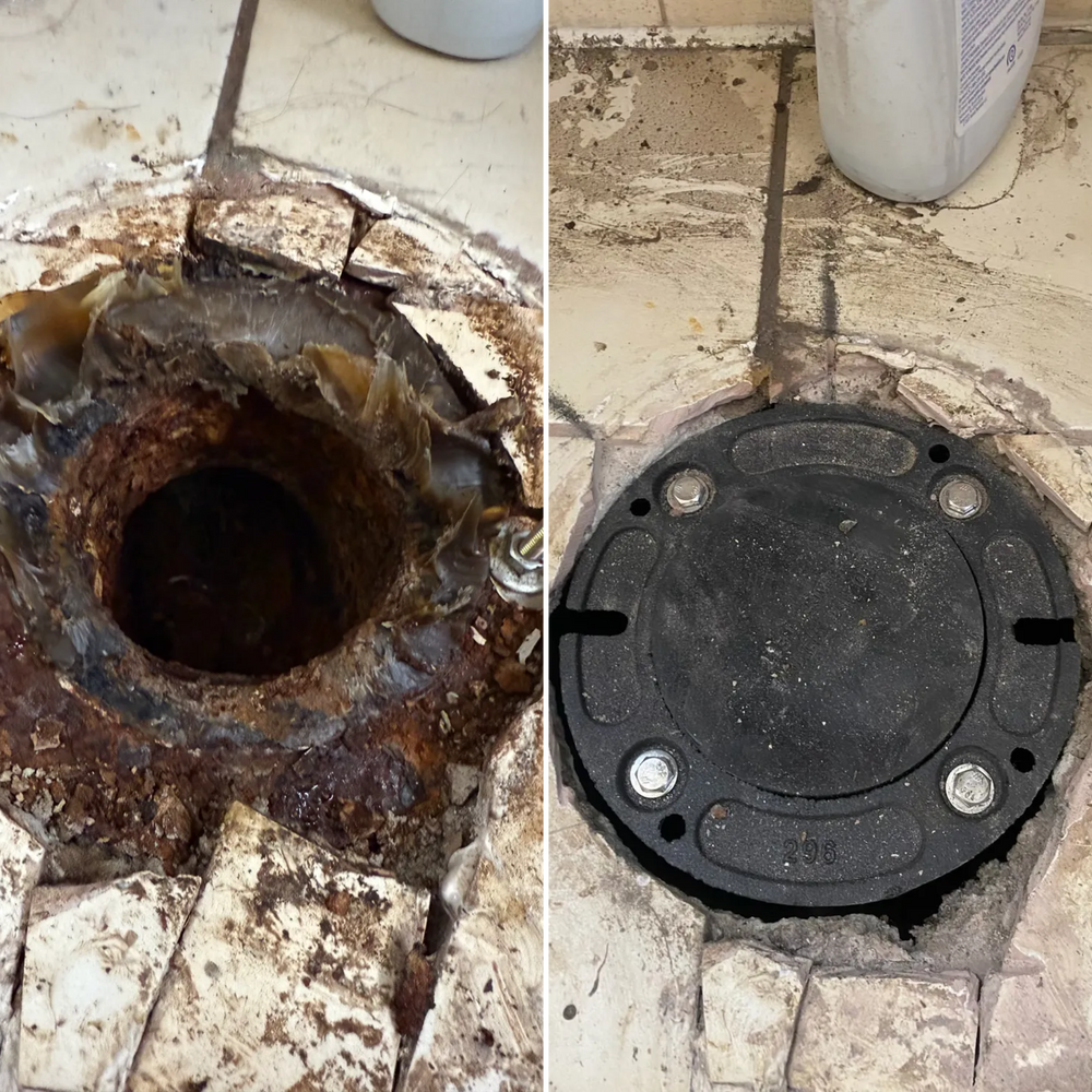 Rusty broken floor drain beside a new black drain cover on tiled floor