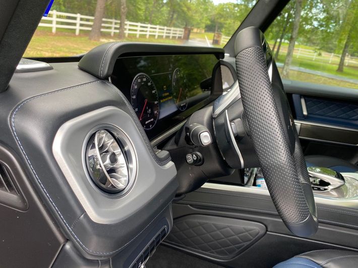 A close up of the steering wheel and dashboard of a car