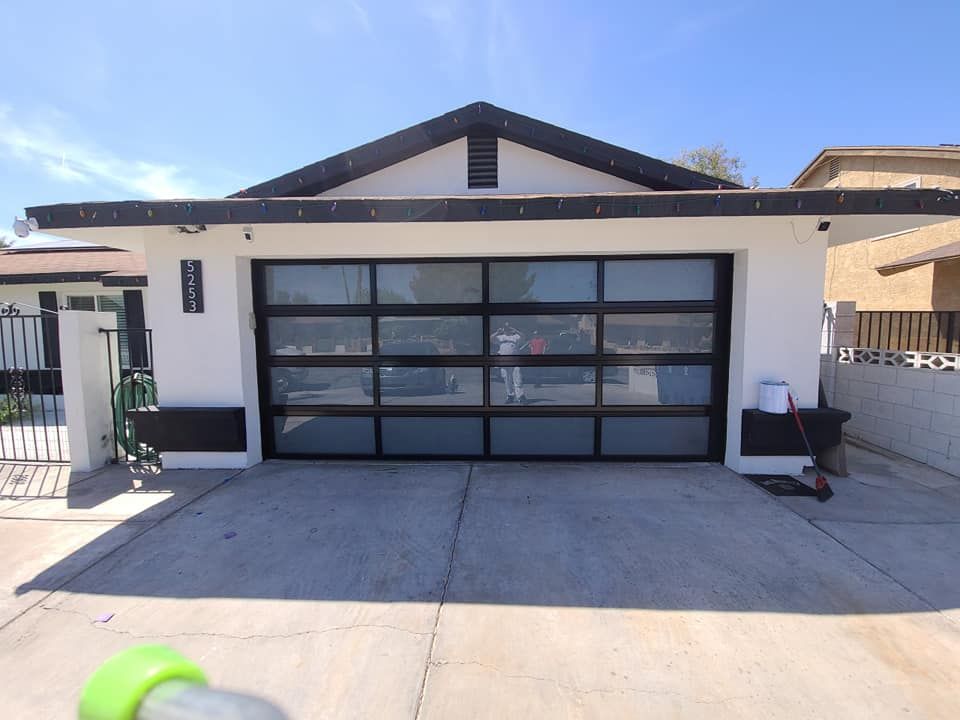A white house with a black garage door