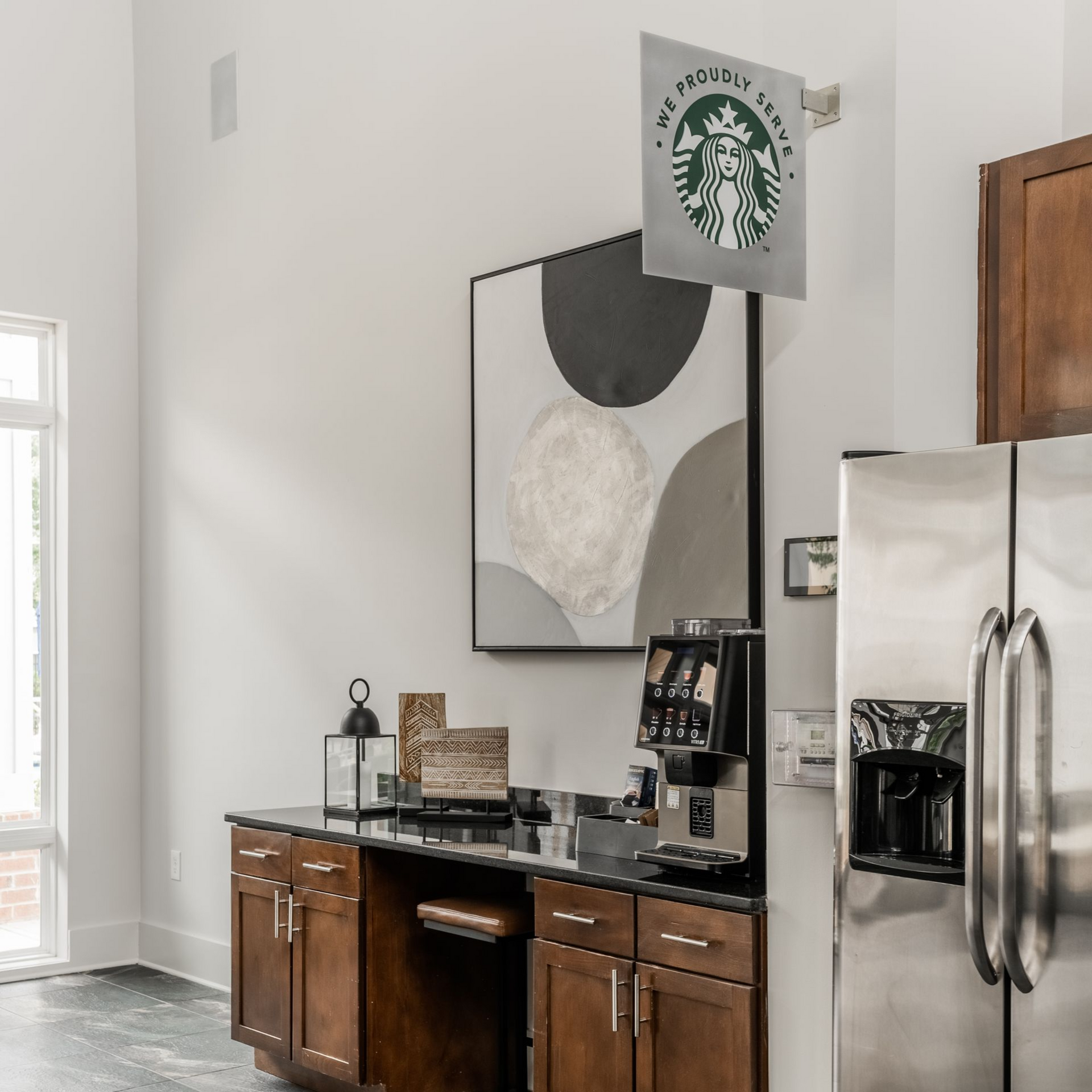 Coffee station with espresso machine, refrigerator, and Starbucks sign at Willows at Fort Mill, offers 1,2, and 3 bedroom apartments in Fort Mill, SC.